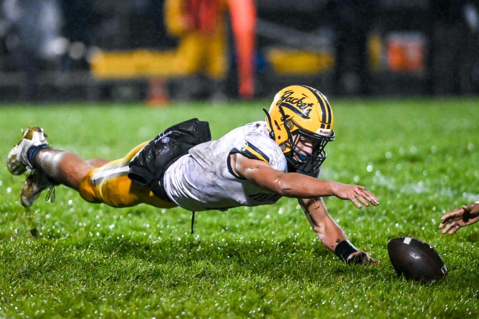 Ithaca's Bronson Bupp dives after a fumble during the first quarter in the game against Pewamo-Westphalia on Friday, Oct. 29, 2021, at Pewamo-Westphalia High School. The Pirates recovered the ball on the play.