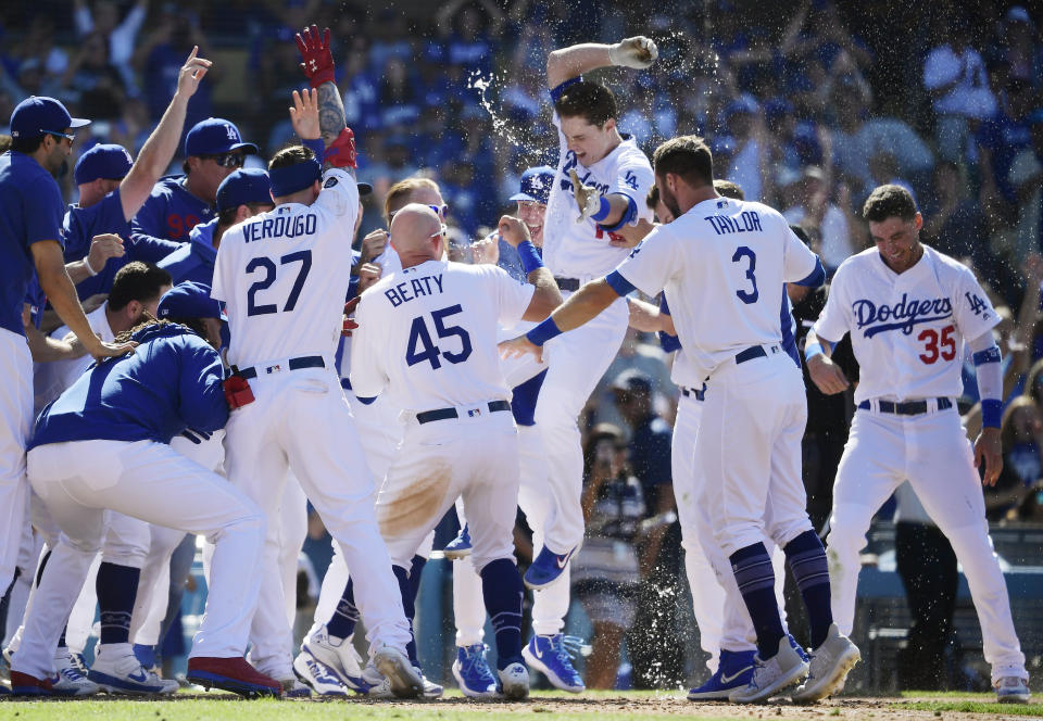 Los Angeles Dodgers' Will Smith, third from right, scores as teammates celebrate after hitting a two-run walkoff home run during the ninth inning of a baseball game against the Colorado Rockies Sunday, June 23, 2019, in Los Angeles. (AP Photo/Mark J. Terrill)