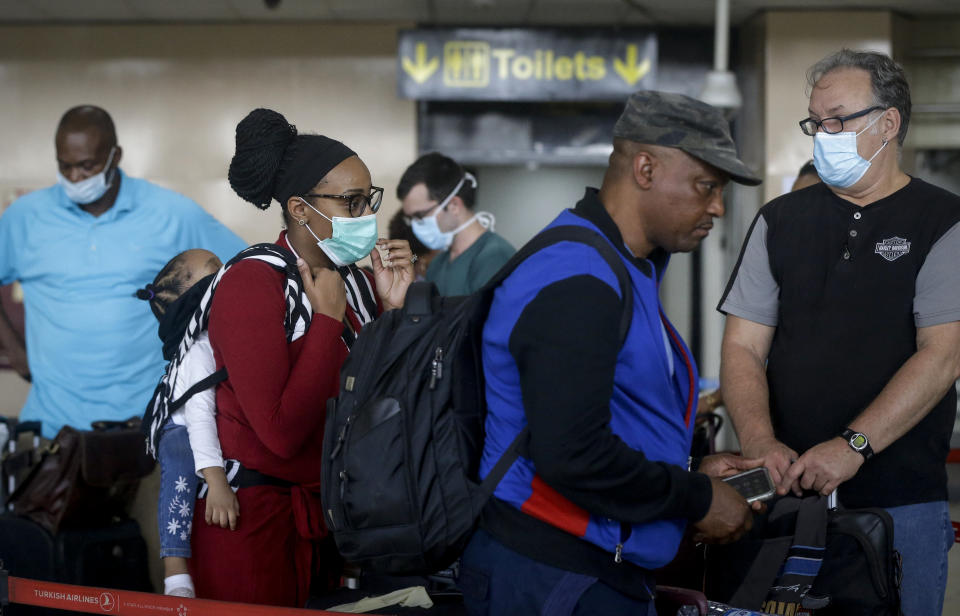 U.S. citizens queue to check in and be repatriated aboard an evacuation flight arranged by the U.S. embassy and chartered with Delta Air Lines, at the Murtala Mohammed International Airport in Lagos, Nigeria Tuesday, April 7, 2020. The new coronavirus causes mild or moderate symptoms for most people, but for some, especially older adults and people with existing health problems, it can cause more severe illness or death. (AP Photo/Sunday Alamba)