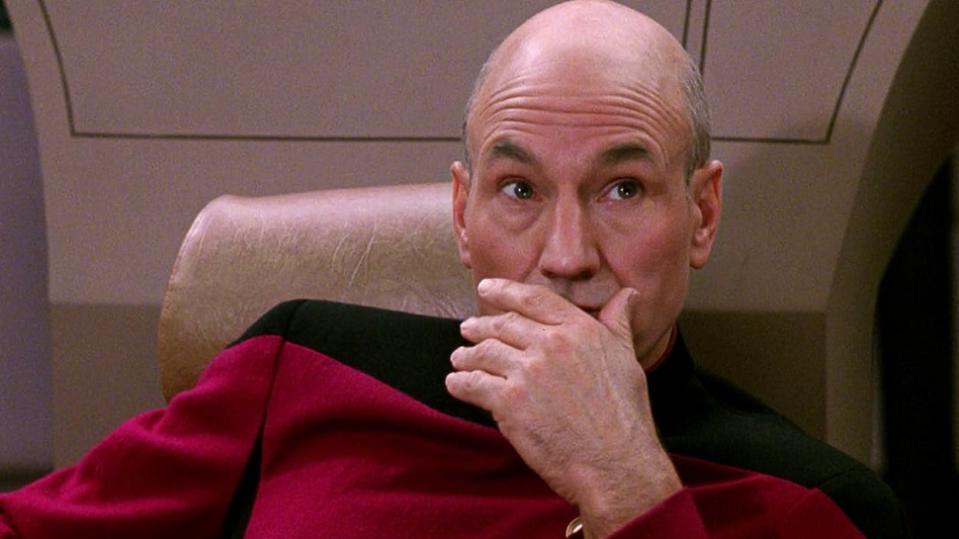 Jean-Luc Picard with his hand over his mouth on Star Trek: The Next Generation