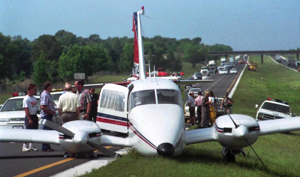 Eastbound traffic on Interstate 4 between Daytona Beach and Orlando, backs up behind a twin engine plane that landed on the highway Wednesday, May 3, 1995, during rush hour after having engine trouble. It came to rest with one wing blocking both lanes. Traffic was funneled onto the shoulder but the morning rush never recovered.