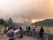 <p>People at a viewpoint overlooking the Columbia River watching the Eagle Creek wildfire burning in the Columbia River Gorge east of Portland, Ore., Sept. 4, 2017. (Photo: Inciweb via AP) </p>