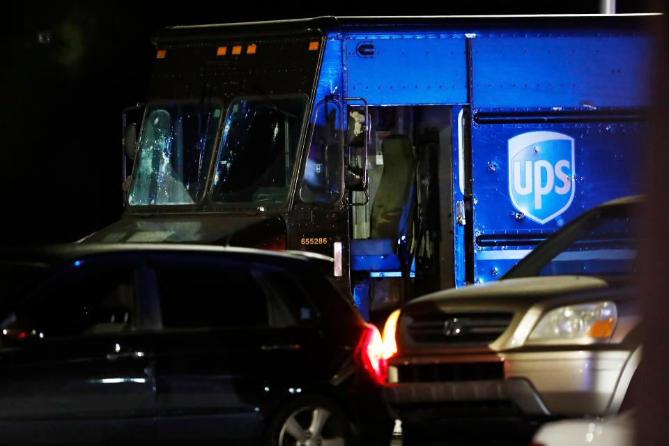 Authorities investigate the scene of a shooting Thursday, Dec. 5, 2019, in Miramar, Fla. Four people, including a UPS driver, were killed Thursday after robbers stole the driver's truck and led police on a chase that ended in gunfire at a busy Florida intersection during rush hour, the FBI said.