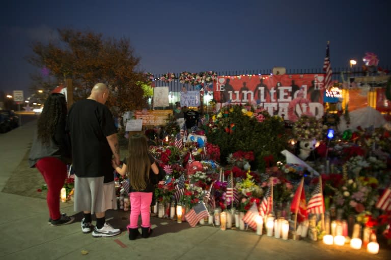 People visit a makeshift memorial near the Inland Regional Center in San Bernardino, California, December 21, 2015 after an attack killed 14 people and injured many others