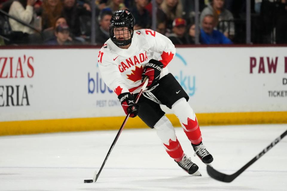 Canada defender Ashton Bell skates with the puck against the United States during the first period of a rivalry series women's hockey game Wednesday, Nov. 8, 2023, in Tempe, Ariz. (AP Photo/Ross D. Franklin)