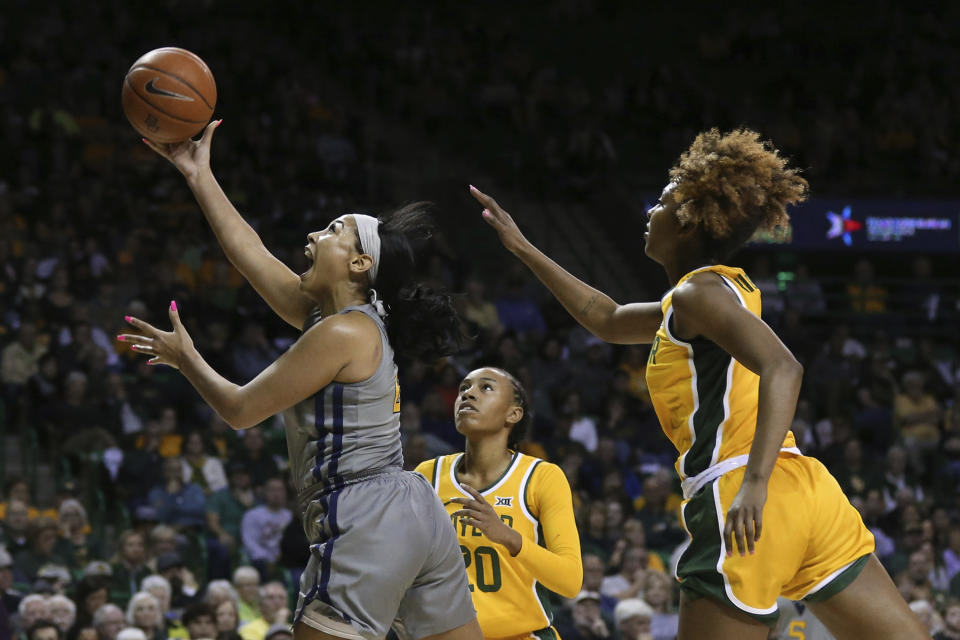 West Virginia guard Kysre Gondrezick, left, scores past Baylor guard DiDi Richards, right, in the first half of an NCAA college basketball game, Saturday, Jan. 18, 2020, in Waco, Texas. (AP Photo/Rod Aydelotte)