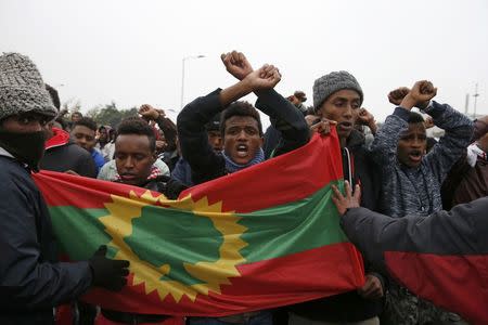 Ethiopian migrants, members of the Oromo community, react as they leave the "Jungle" to be transfered to reception centers during the start of the dismantlement of the camp in Calais, France, October 24, 2016. REUTERS/Pascal Rossignol