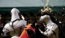 <p>Australian knight Philip Leitch ® has a floral basket on his helmet smashed by an opponent at the St Ives Medieval Fair in Sydney, one of the largest of its kind in Australia, Sept. 25, 2016. (Photo: Jason Reed/Reuters)</p>