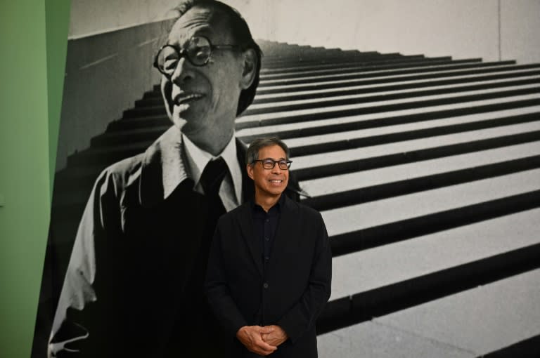 Sandi Pei, son of renowned Chinese-American architect I.M. Pei, poses in front of a photo of his father at a new exhibit at Hong Kong's M+ museum (Peter PARKS)