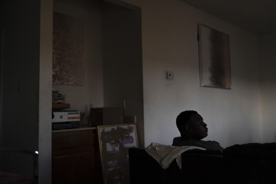 John Simon, a teenager who had a bariatric surgery in 2022, rests in his apartment in Los Angeles, Monday, March 13, 2023. (AP Photo/Jae C. Hong)