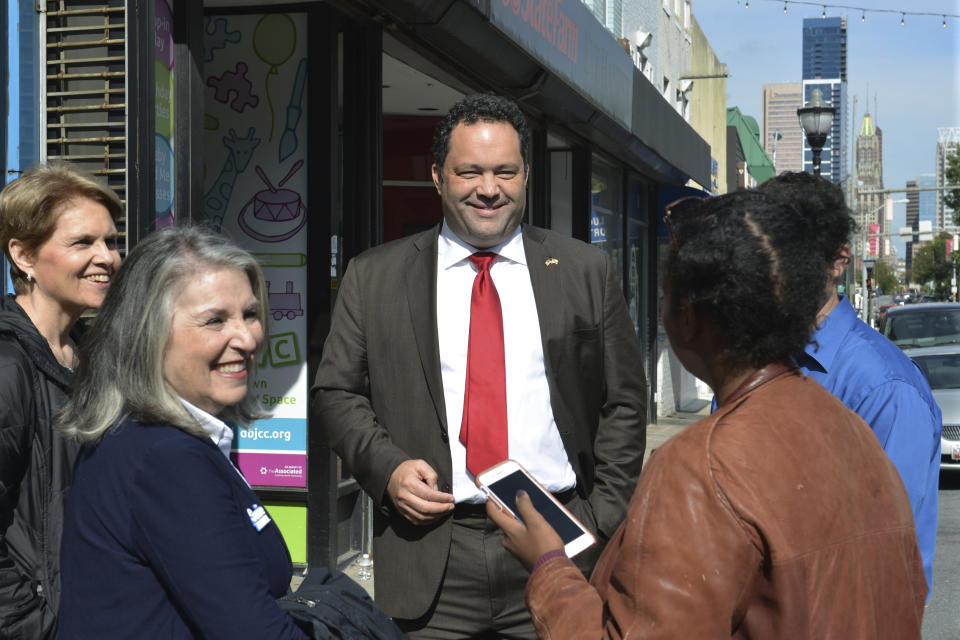 Ben Jealous, a former NAACP president who is running as a Democrat for governor of Maryland, talks to people in Baltimore's Federal Hill neighborhood on Tuesday, Oct. 16, 2018, about his campaign to unseat Republican Gov. Larry Hogan. Jealous says he would support broadening a new Maryland gun-control law to restrict firearms access to people found to be a risk to themselves or others, if elected governor. (AP Photo/David McFadden)