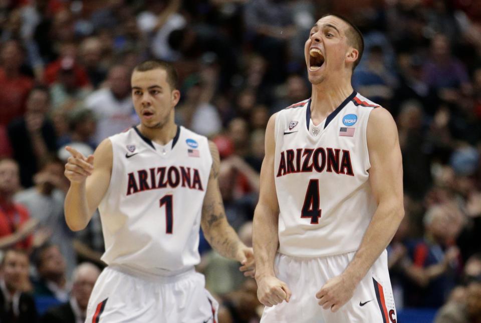 In this March 27, 2014, file photo, Arizona guard Gabe York (1) and Arizona guard T.J. McConnell (4) cheer during the second half in a regional semifinal NCAA college basketball tournament game against San Diego State in Anaheim, Calif. (AP Photo/Jae C. Hong, File)