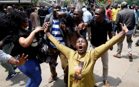 Supporters of opposition leader Raila Odinga cheer outside court  - Credit: BAZ RATNER/Reuters