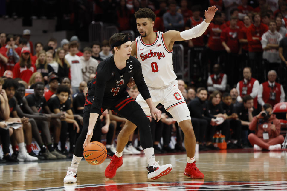 Rutgers' Paul Mulcahy, left, is defended by Ohio State's Tanner Holden during the second half of an NCAA college basketball game Thursday, Dec. 8, 2022, in Columbus, Ohio. (AP Photo/Jay LaPrete)