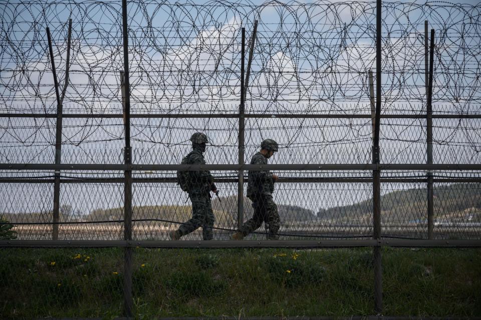 South Korean soldiers patrol along a barbed wire fence Demilitarized Zone (DMZ) separating North and South Korea, on the South Korean island of Ganghwa on April 23, 2020. - The United States will keep seeking North Korea's denuclearization no matter who is in charge in Pyongyang, Secretary of State Mike Pompeo said, amid speculation about leader Kim Jong Un's health. (Photo by Ed JONES / AFP) (Photo by ED JONES/AFP via Getty Images)