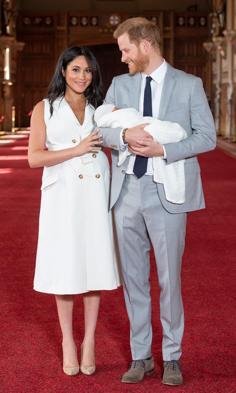 Prince Harry, Duke of Sussex and Meghan, Duchess of Sussex, pose with their newborn son Archie Harrison Mountbatten-Windsor during a photocall in St George's Hall at Windsor Castle on May 8, 2019 in Windsor, England. The Duchess of Sussex gave birth at 05:26 on Monday 06 May, 2019