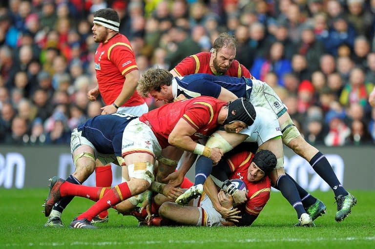 Wales' Sam Davies clings to the ball as he is tackled tackled to the ground during the Six Nations international rugby union match against Scotland Febuary 25, 2017