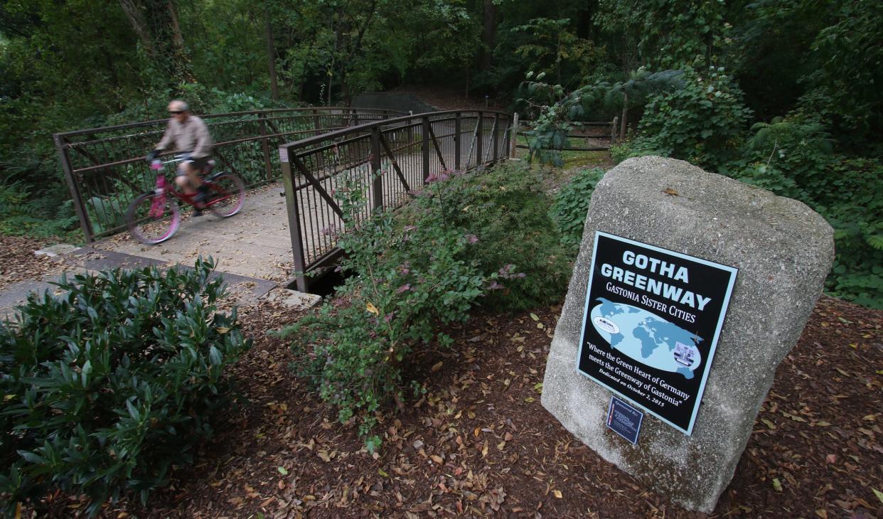 A man rides his bike along the greenway near Lineberger Park Thursday morning, Sept. 30, 2021.