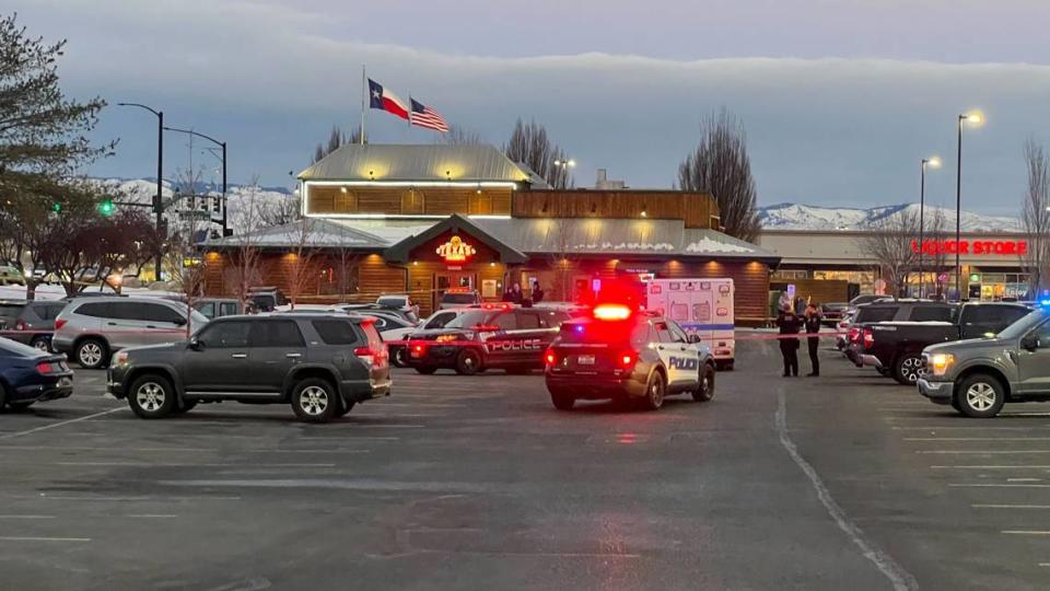 Police vehicles and an ambulance, as well as police tape, mark the scene of the police shooting, involving Eli Nash, behind the Texas Roadhouse along Fairview Avenue, just west of the Boise-Meridian city line.