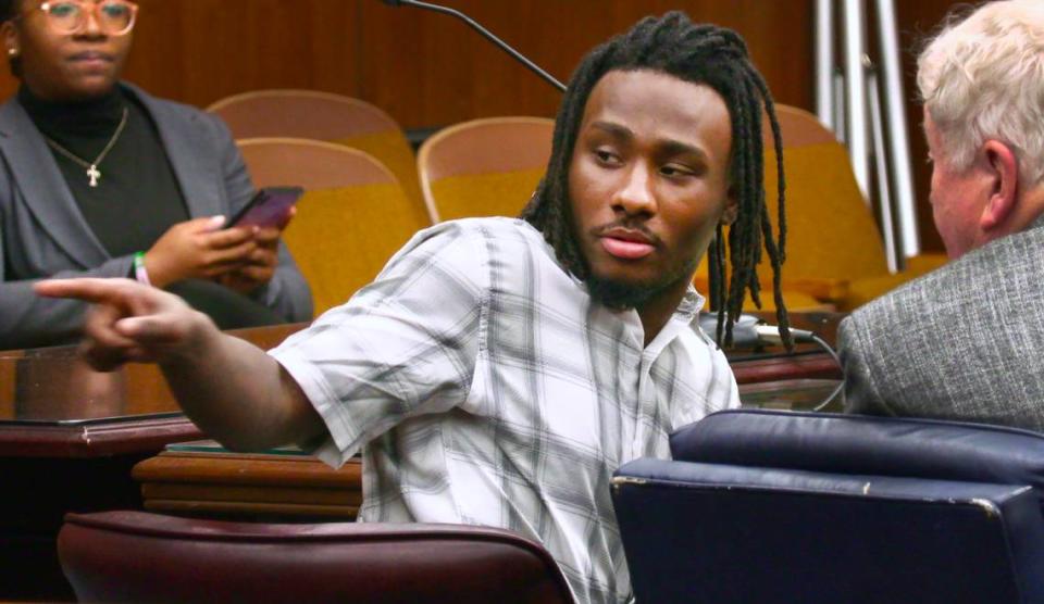 Lydell Maynard “Trapa” Sparks, center, motions to the back of the courtroom while waiting for court to resume Tuesday afternoon. 06/14/2022 Mike Haskey/mhaskey@ledger-enquirer.com