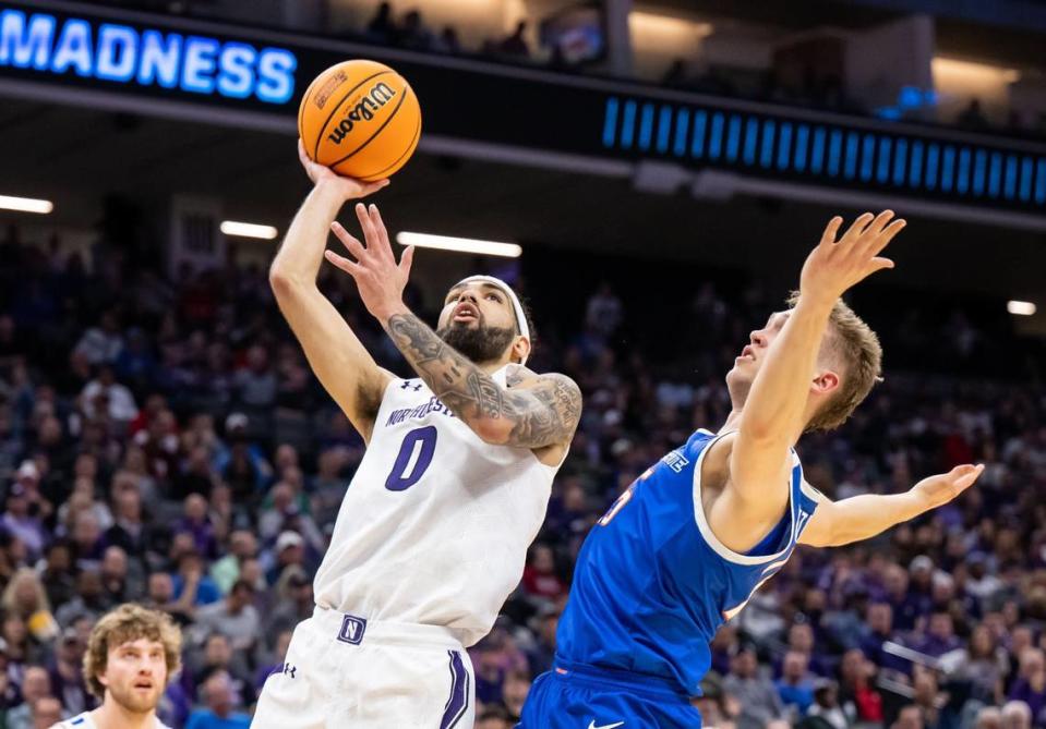 Northwestern Wildcats guard Boo Buie (0), left, goes up for two points as Boise State Broncos guard Jace Whiting (15) defends during the first half of the NCAA Tournament at Golden 1 Center on Thursday, March 16, 2023, in Sacramento.