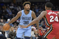 Memphis Grizzlies guard Marcus Smart (36) handles the ball against Miami Heat forward Haywood Highsmith (24) in the first half of an NBA basketball game, Wednesday, Nov. 8, 2023, in Memphis, Tenn. (AP Photo/Brandon Dill)