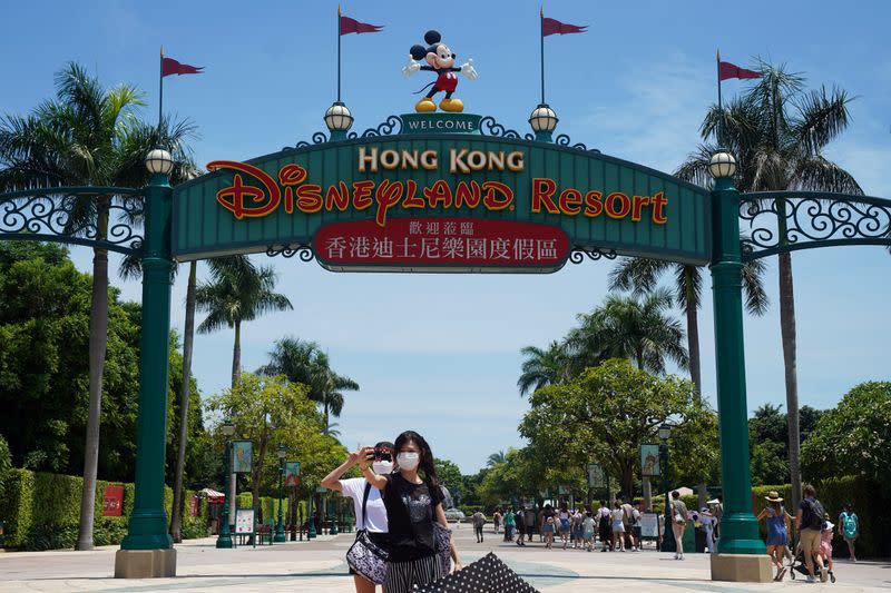 Visitors take pictures at the Hong Kong Disneyland Resort in Hong Kong