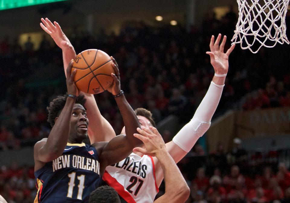 Pelicans guard Jrue Holiday, left, shoots next to Trail Blazers center Jusuf Nurkic during the first half of Game 2 Tuesday night. (AP)