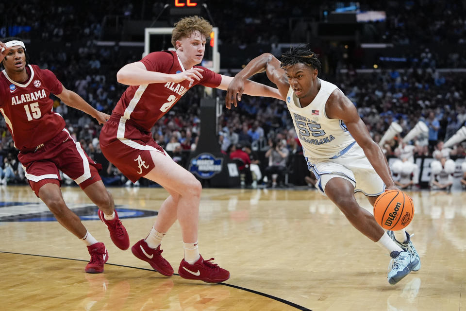 North Carolina forward Harrison Ingram (55) dribble past Alabama forward Sam Walters during the second half of a Sweet 16 college basketball game in the NCAA tournament Thursday, March 28, 2024, in Los Angeles. (AP Photo/Ryan Sun)