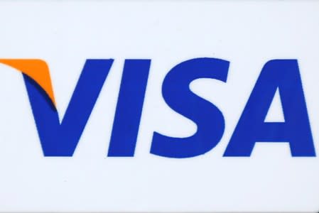 FILE PHOTO: The logo of Dow Jones Industrial Average stock market index listed company Visa (V) is seen in Los Angeles