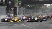 Colton Herta (26) leads the field during the IndyCar Detroit Grand Prix auto race in Detroit, Sunday, June 2, 2024. (AP Photo/Paul Sancya)