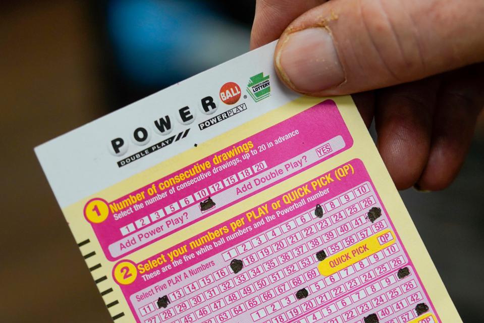 FILE - A person shows their scan card for their personal selection numbers for a ticket for a Powerball drawing on Nov. 7, 2022, at a convenience store in Renfrew, Pa. A winning ticket has been sold in California for Wednesday's drawing on July 19, 2023, for the Powerball jackpot worth $1 billion. (AP Photo/Keith Srakocic, File) ORG XMIT: NYCD503