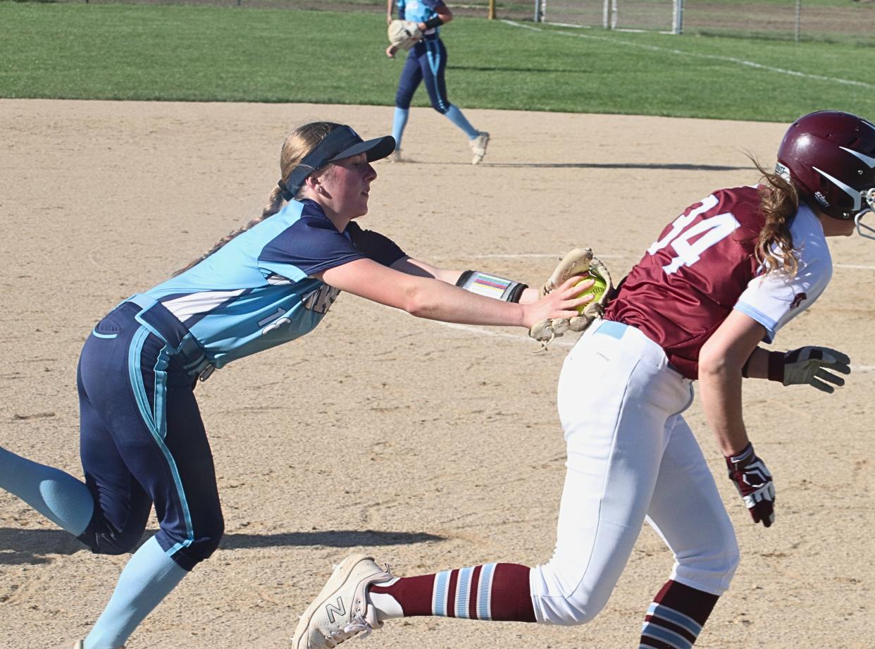 Prairie Central shortstop Sam Slagel tags out Chayse Palmer of St. Joseph-Ogden after a rundown.