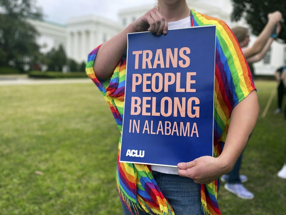 FILE - A person holds up a sign reading, "Trans People Belong in Alabama," during a rally outside the Alabama Statehouse in Montgomery, Ala., on International Transgender Day of Visibility, March 31, 2023. Sunday, March 31, 2024 is International Transgender Day of Visibility, a day full of events around the world to bring attention to a population that's often ignored or disparaged or victimized. (AP Photo/Kim Chandler, File)