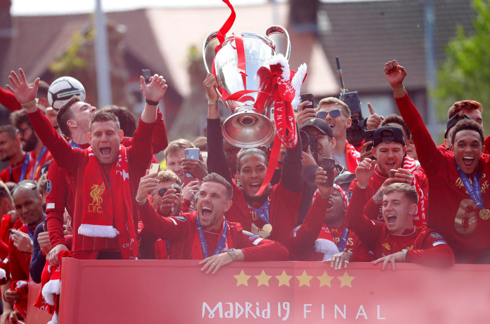 Soccer Football - Champions League - Liverpool victory parade - Liverpool, Britain - June 2, 2019  Liverpool's Jordan Henderson, James Milner, Trent Alexander-Arnold, Virgil van Dijk and team mates with the trophy during the parade  REUTERS/Phil Noble