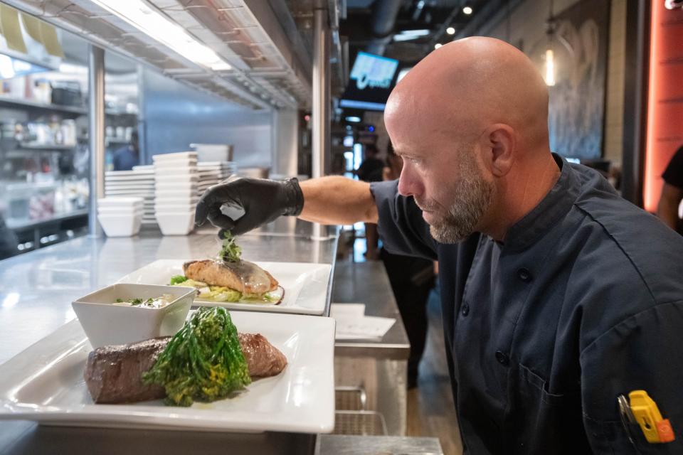 Executive chef Jacob Childers garnishes a plate at the new BarSteak restaurant on Palafox Place during a soft opening in downtown Pensacola on Tuesday, Oct. 3, 2023.