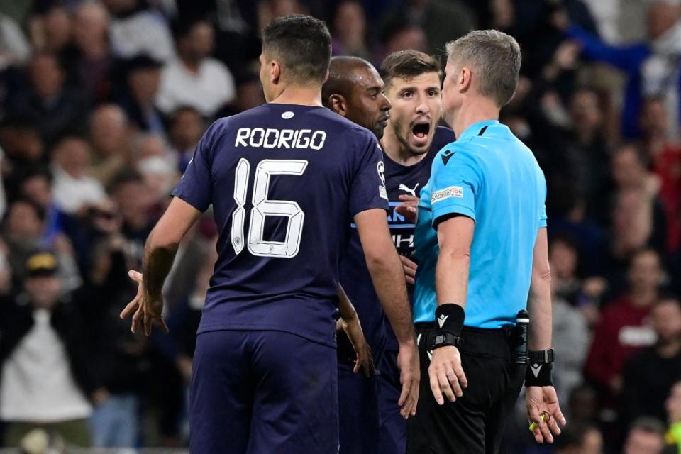 City players surround referee Orsato after he awarded Real’s tie-winning penalty (AFP via Getty)