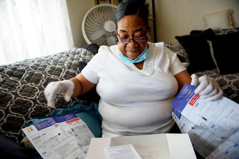 Diane Bell opens instructions included in a home test kit for at her home on April 21 in Greenville, N.C.