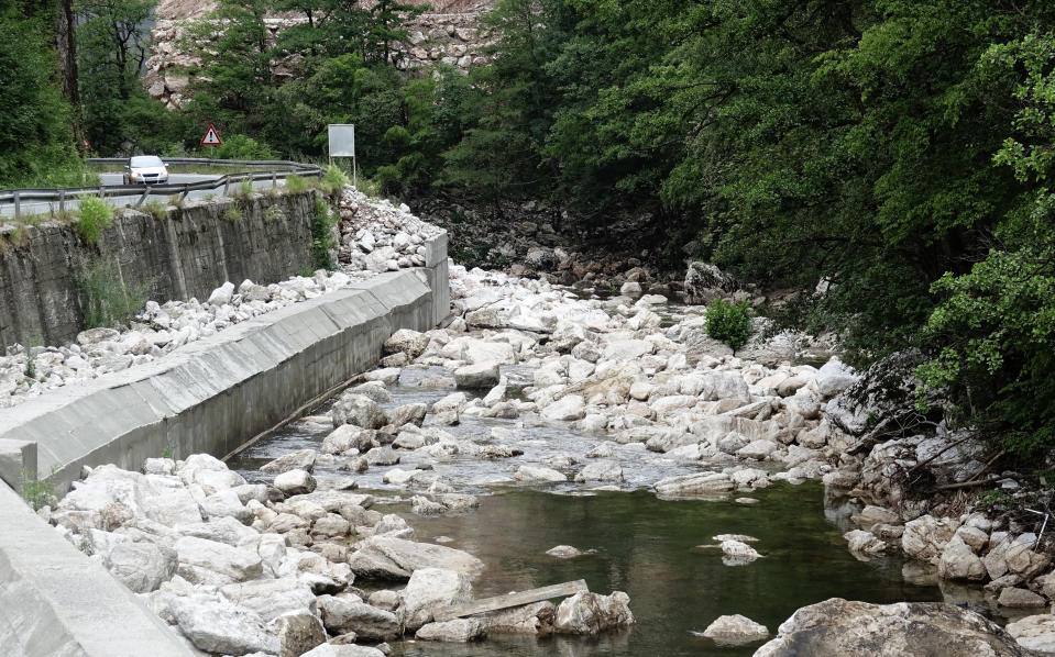 A car pass by construction of a small hydro power plant on Zeljeznica river near the town of Trnovo, Saturday, July 9, 2022. It took a decade of court battles and street protests, but Balkan activists fighting to protect some of Europe's last wild rivers have scored an important conservation victory in Bosnia. A new electricity law, which passed Thursday, bans the further construction of small hydroelectric power plants in the larger of Bosnia's two independent entities. (AP Photo/Eldar Emric)