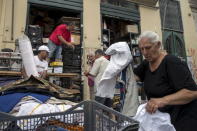 People prepare their stuff for sale at a flea market in Athens, Greece, June 22, 2015. REUTERS/Marko Djurica