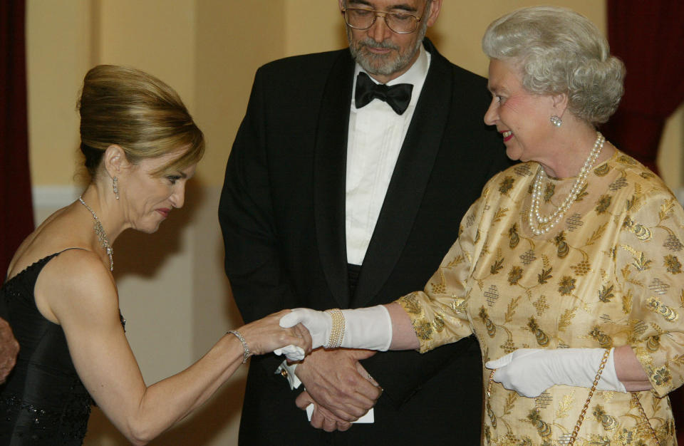 Queen Elizabeth II meets pop star and actress Madonna (L) watched by producer Michael Wilson at the World premiere of the latest Bond movie "Die another Day", at the Royal Albert Hall.