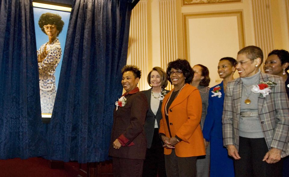 FILE- In this March 3, 2009, file photo, House Speaker Nancy Pelosi, second left, joins members of the Congressional Black Caucus on Capitol Hill in Washington, for the unveiling of the portrait of the late Rep. Shirley Chisholm, D-NY. The event marked the 40th anniversary of Congresswoman Chisholm's swearing in as a member of the House of Representatives. From left are Congressional Black Caucus Chair Rep. Barbara Lee, D- Calif., Nancy Pelosi, Rep. Maxine Waters, D-Calif., Eleanor Holmes Norton, D-D.C., Rep. Donna Edwards, D-Md., and Rep. Yvette Clarke, D-N.Y. (AP Photo/Manuel Balce Ceneta, File)