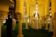 <p>Qatari defence ministry staff members wait nearby as Qatar’s Minister of Defence Khalid bin Mohammad Al-Attiyah welcomes Defence Secretary James Mattis (neither pictured) for a meeting and poolside dinner at his residence on April 22, 2017 in Doha, Qatar. (Photo: Jonathan Ernst-Pool/Getty Images) </p>