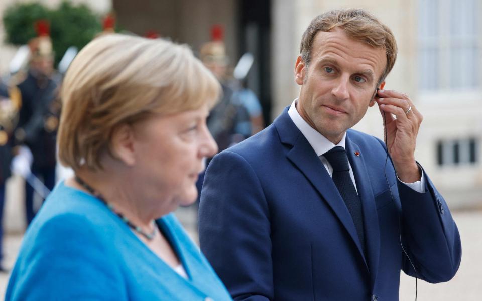 German Chancellor Angela Merkel and French President Emmanuel Macron - AFP