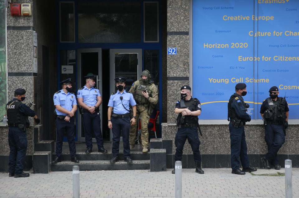 Kosovo police guard the entrance of the offices of a war veterans association in Kosovo, in Pristina, Friday, Sept. 25, 2020. Witnesses say European Union security police have stormed the offices of a war veterans association in Kosovo. The association represents the former ethnic Albanian separatists who fought Serbian troops in a 1998-1999 war for independence. Members of the group said police from the European Union Rule of Law Mission in Kosovo, or EULEX, prevented them from going into the association’s offices in Pristina on Friday. (AP Photo/Visar Kryeziu)