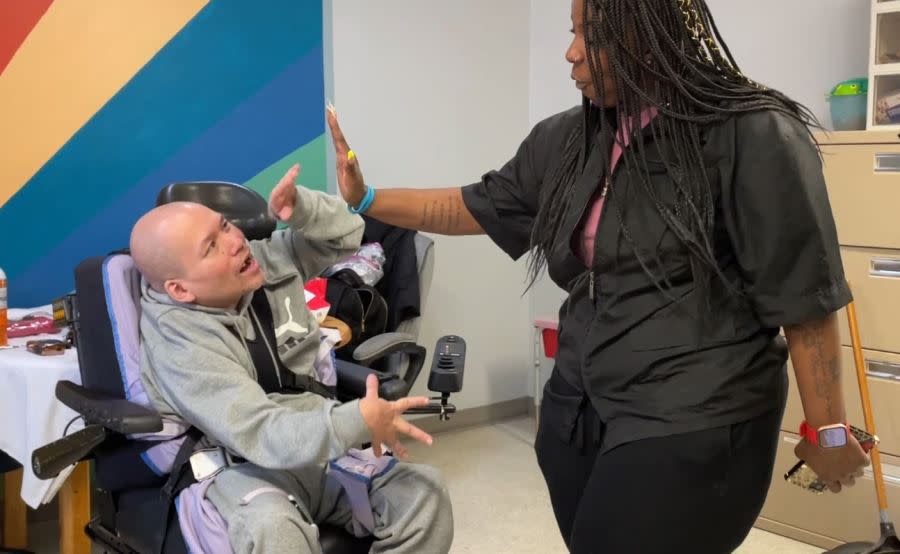 Leathers high-fiving client J.J. after his haircut (Chloe Rafferty/CBS 17)