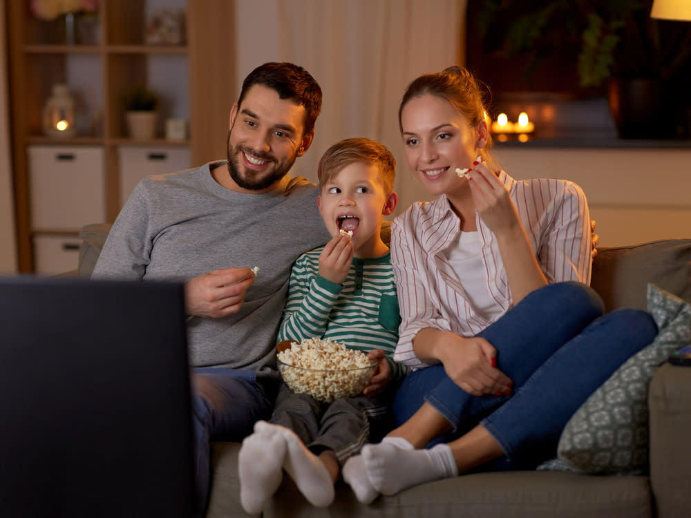 Eine junge Familie bei der abendlichen Unterhaltung vor dem TV (Bild: Syda Productions/Shutterstock.com)