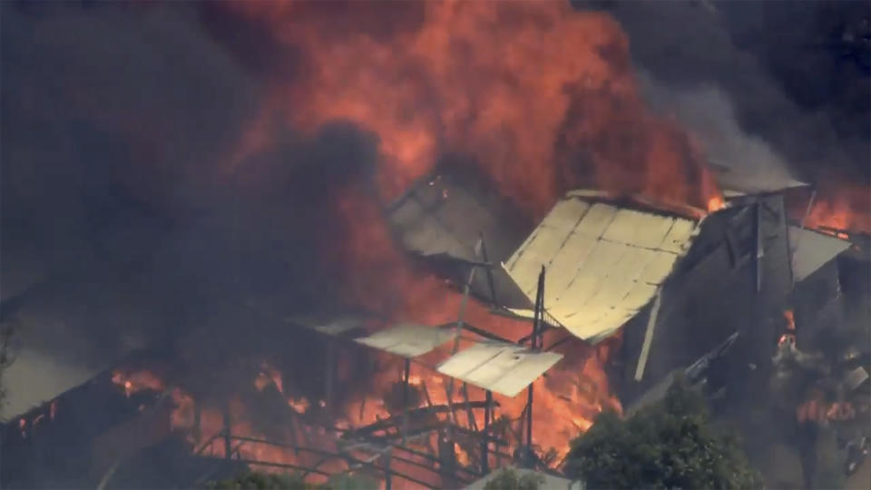 This image made from video shows home engulfed in flames outside Perth, Australia, Thursday, Dec. 21, 2023. A wildfire burning out of control on the outskirts of the Australian west coast city of Perth on Thursday appeared to have destroyed or damaged a number of homes. (Australian Broadcasting Corp/Channel 7/Channel 9 via AP)