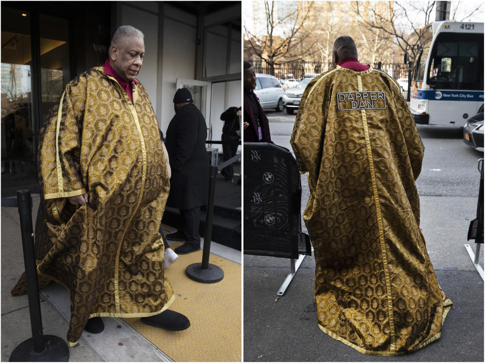 Fashion journalist Andre Leon Talley walks outside a show during Fashion Week, Wednesday, Feb. 12, 2020, in New York. He wears a cape with the name "Dapper Dan." (AP Photo/Mark Lennihan)