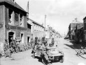 U.S. Army paratroopers of the 101st Airborne Division drive a captured German Kübelwagen on D-Day at the junction of Rue Holgate and RN13 in Carentan, France, on June 6, 1944. (Photo: U.S. National Archives/handout via Reuters)